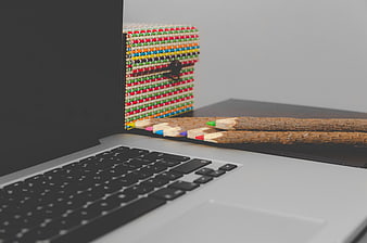 Creative workspace with bark-textured pencils and colorful box