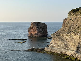 Dramatic coastal landscape with sea stack and cliffs