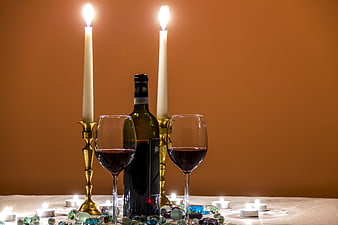 Romantic candlelit dinner with red wine and glasses