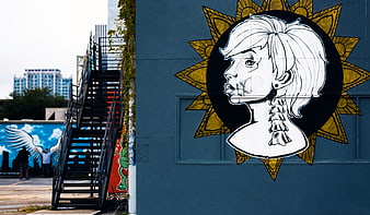 Urban street art mural of woman with exposed spine