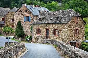 Stone houses in a French village with a winding road