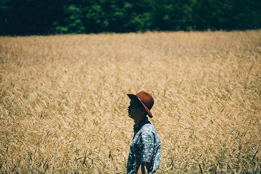 Man in Fedora Standing in Golden Wheat Field