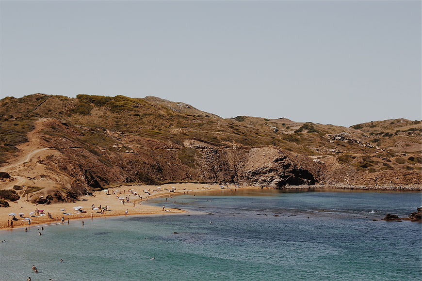 Sandy Beach Cove with Turquoise Water and Arid Hills
