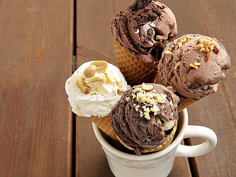 Assorted Ice Cream Cones in White Mug on Wooden Table
