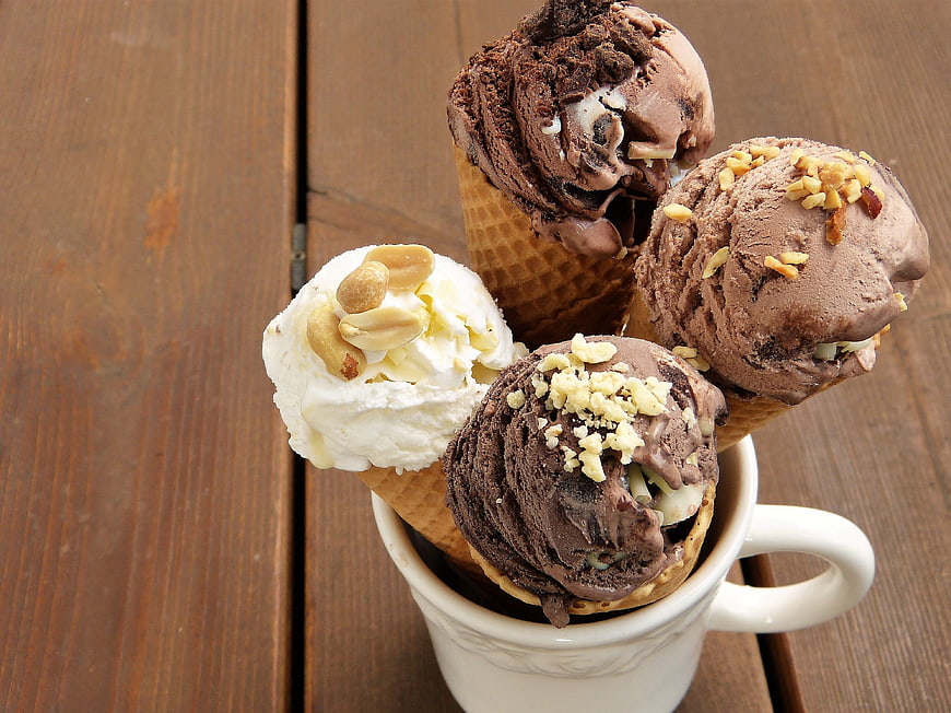 Assorted Ice Cream Cones in White Mug on Wooden Table