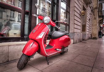 Red Vintage Scooter Parked on City Sidewalk