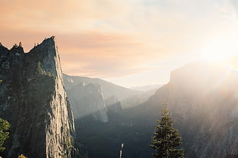 Sunset view of Yosemite Valley with granite cliffs and pine trees