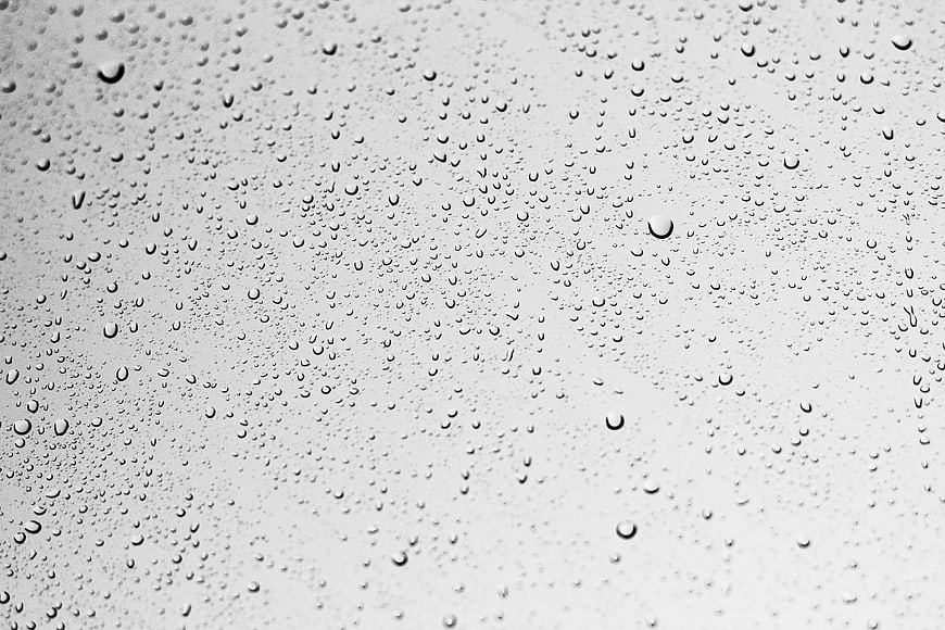 Black and white raindrops on glass window texture background