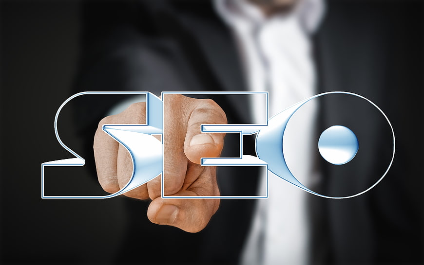 Businessman touching SEO text on digital interface