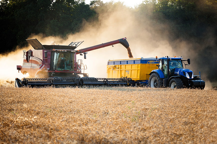 Combine Harvester Unloading Grain into Tractor Trailer