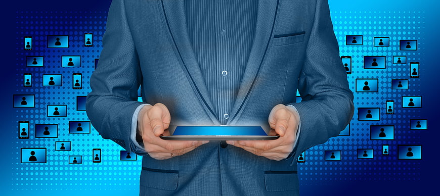 Businessman holding tablet with digital network connection icons