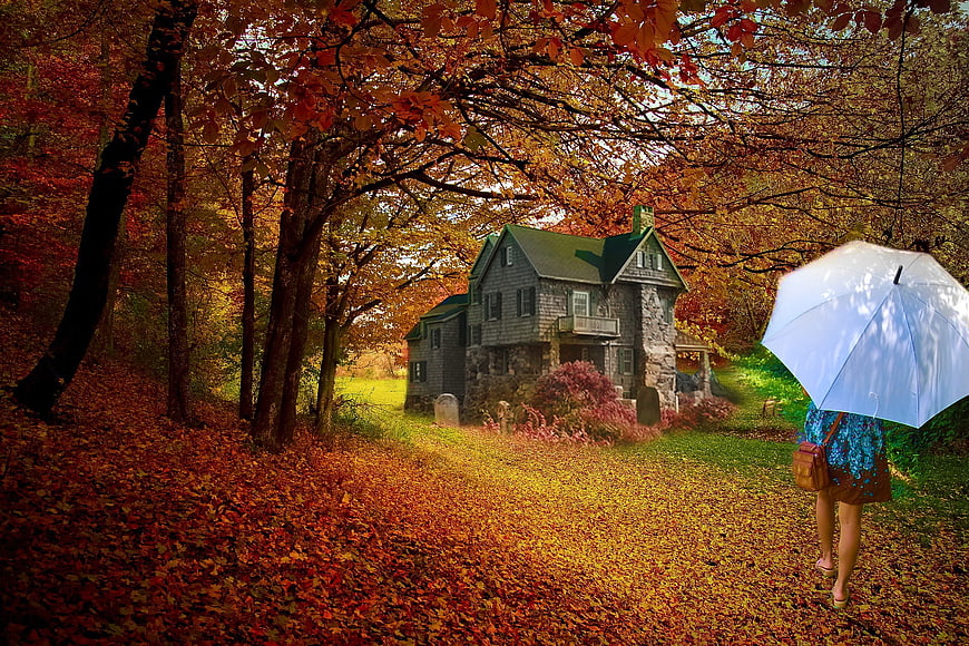 Woman with Umbrella Walking Past Old House in Autumn Forest