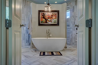 Modern bathroom with freestanding tub and herringbone tile