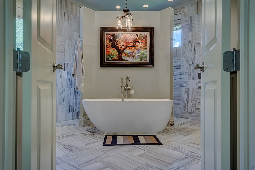 Modern bathroom with freestanding tub and herringbone tile