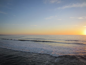 Serene Ocean Sunset with Gentle Waves and Golden Sky