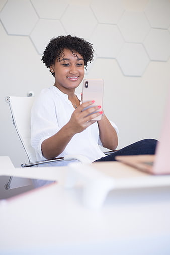 Happy African American Woman Using Smartphone in Modern Office