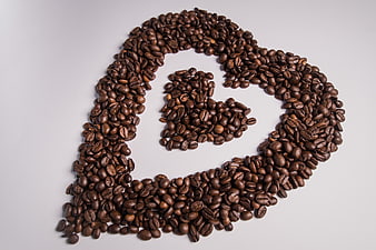 Coffee Beans Arranged in Letter G Shape on White Background