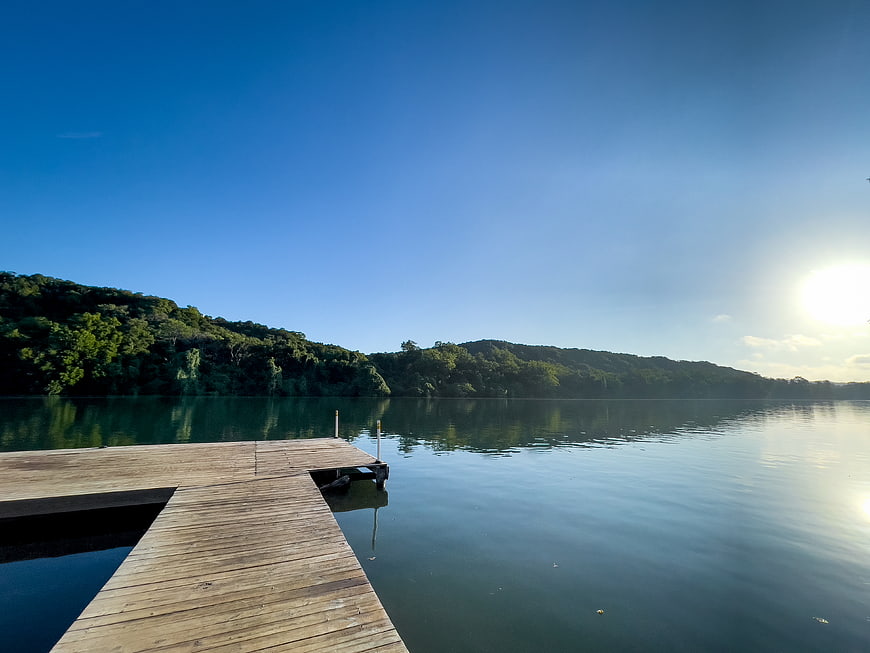 Serene Wooden Dock on Calm Lake at Sunset