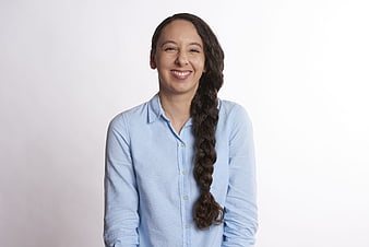 Happy Woman with Long Braid Smiling at Camera