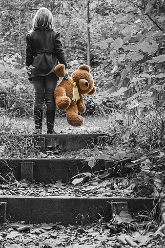 Child Walking Away with Teddy Bear in Forest