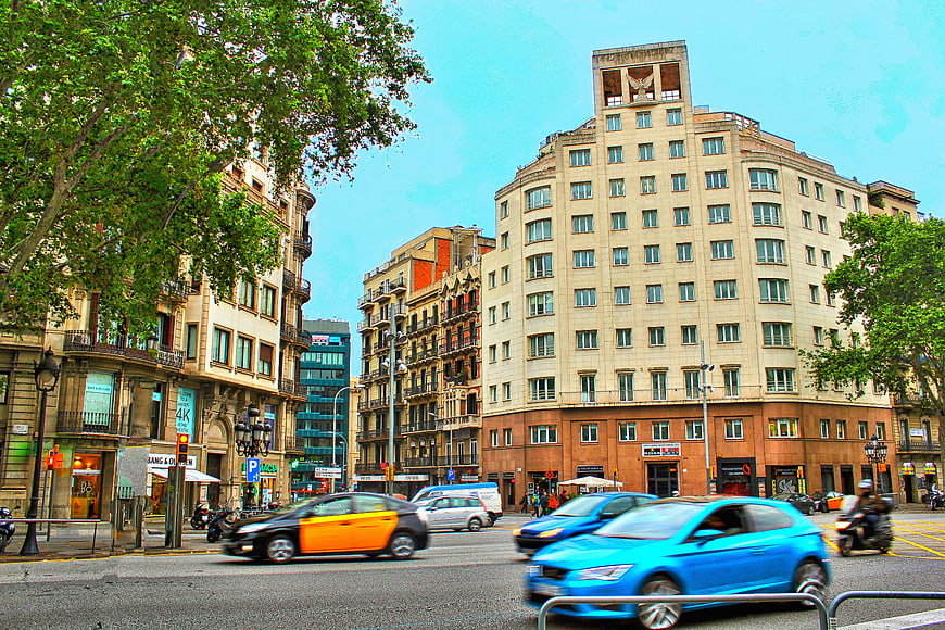 Busy Barcelona street scene with colorful cars and architecture