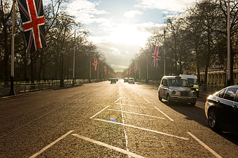 London street with Union Jack flags and black cab