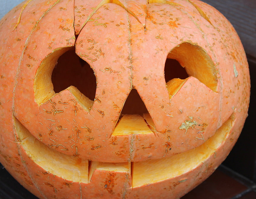 Close-up of a carved orange Halloween pumpkin jack-o'-lantern