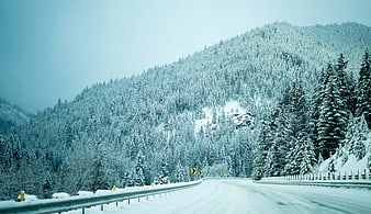 Snowy Mountain Road Winding Through Winter Forest