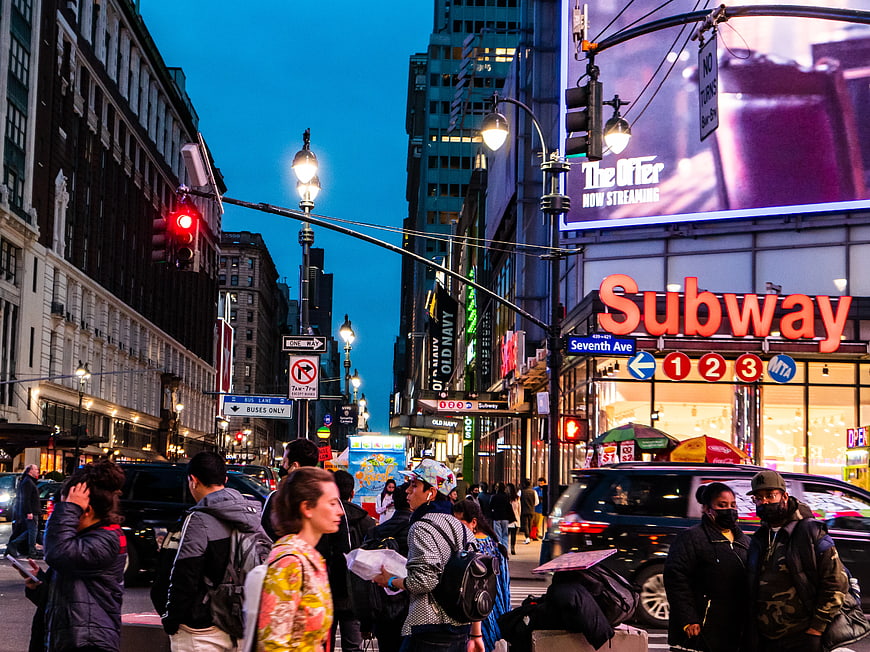 Busy Manhattan Street Scene at Dusk with Subway Entrance