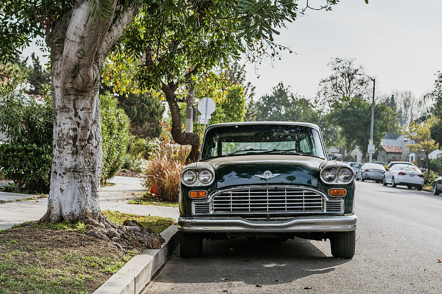 Front view of vintage green classic car parked on street