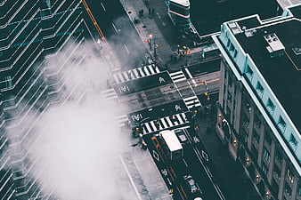 Aerial view of city street intersection with steam rising