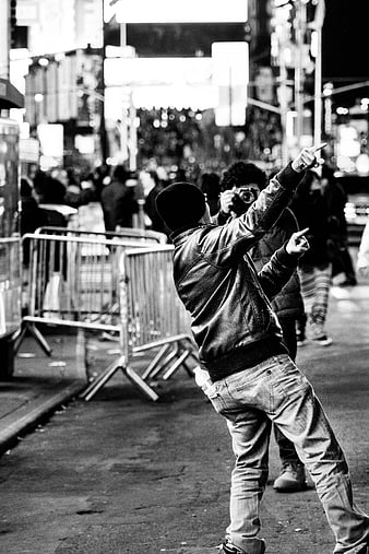Man Pointing in Black and White Night Street Scene