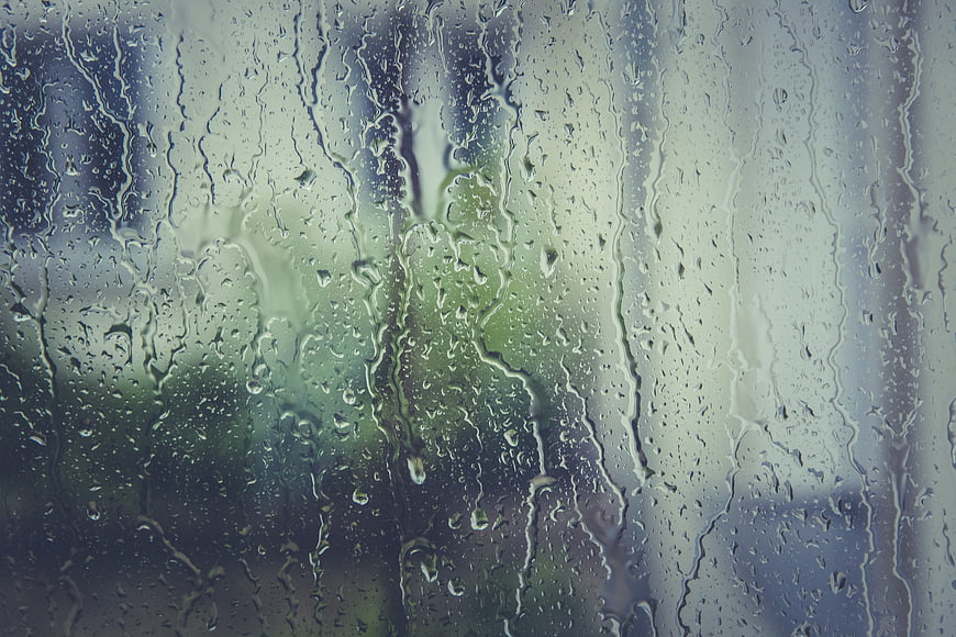 Raindrops on a Window Pane with Blurred Green Background
