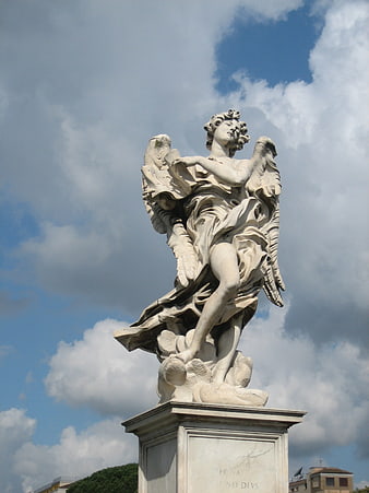 White Marble Angel Statue Against Blue Sky