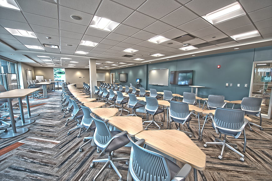 Modern Empty Classroom With Rows Of Desks And Chairs