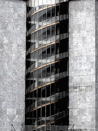 Modern curved glass building facade with concrete walls