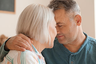 Senior couple embracing with foreheads touching in tender moment