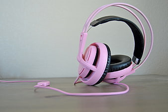 Pink Over-Ear Headset With Microphone On Gray Surface