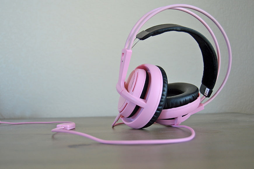 Pink Over-Ear Headset With Microphone On Gray Surface