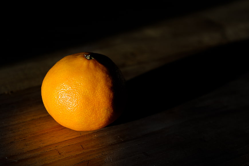 Single Mandarin Orange on Dark Wooden Table