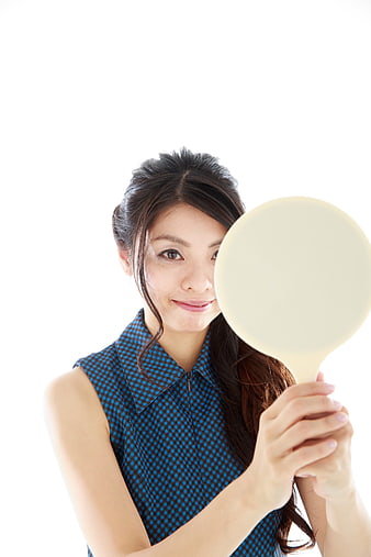 Young Asian Woman Holding Hand Mirror on White Background