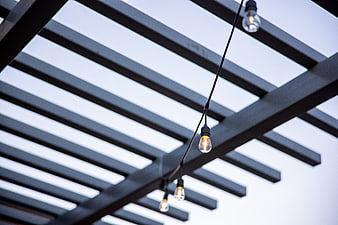 String lights hanging under modern pergola structure