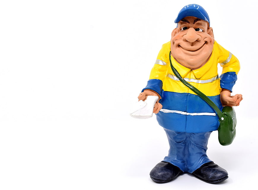 German Postman Figurine in Yellow and Blue Uniform on White Background