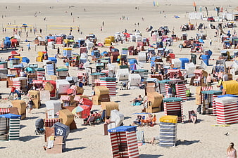 Aerial View of Colorful Beach Huts on Sandy Shore