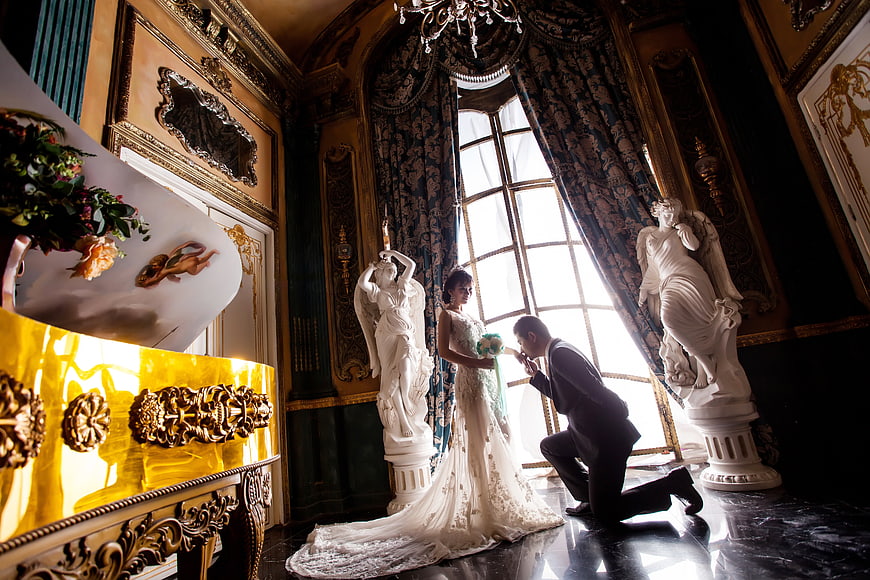 Romantic Wedding Couple Kissing in Luxurious Baroque Palace Interior