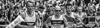 Black and White Photo of Marathon Runners in a Crowd