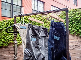 Vintage Denim and Workwear Hanging on Rusty Rack