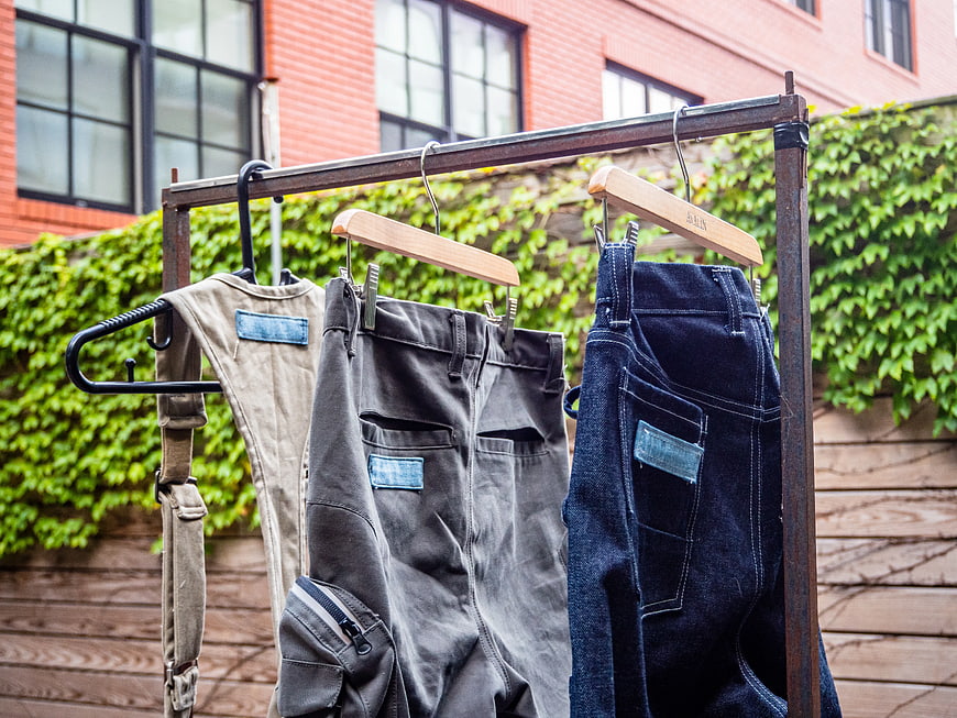 Vintage Denim and Workwear Hanging on Rusty Rack