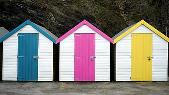 Colorful Beach Huts with Blue, Pink, and Yellow Doors