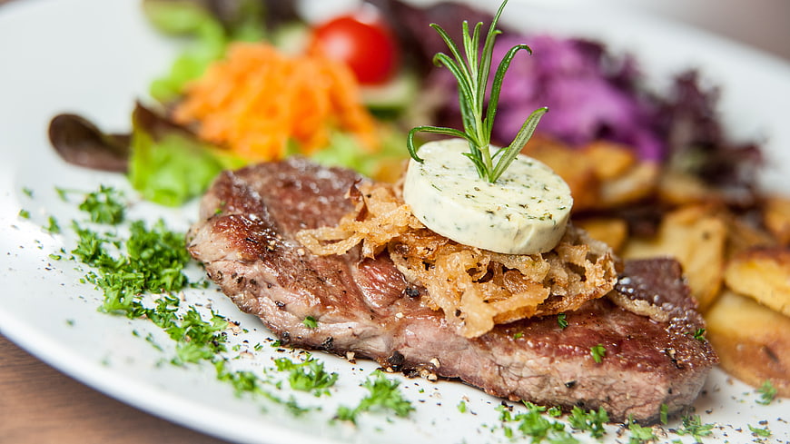 Gourmet Grilled Steak with Blue Cheese and Rosemary Garnish